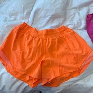 Orange lululemon hotty hot shorts